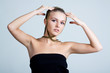 Beautiful woman with gold jewellery faming her face