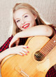bright picture of lovely blond woman in checkered shirt with gui