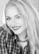 black and white picture of lovely blond woman in checkered shirt