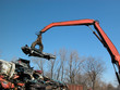 Photo: junkyard crane and claw with crushed car junkyard crane and claw with crushed car