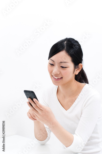 Photo: beautiful asian woman using cellphoe beautiful asian woman using cellphoe