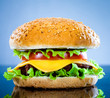 Tasty and appetizing hamburger on a blue Tasty and appetizing hamburger on a blue