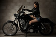 Sexy attractive twenties asian woman sitting on motorcycle