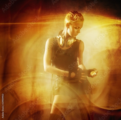 Photo: Attractive steam punk girl against abstract background Attractive steam punk girl against abstract background