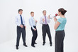 Photo: Female manager talking to businessmen with megaphone Female manager talking to businessmen with megaphone
