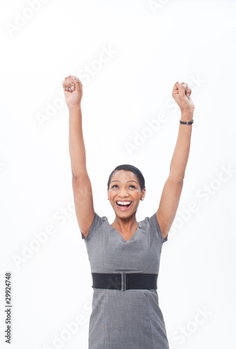Photo: Enthusiastic businesswoman raising her arms Enthusiastic businesswoman raising her arms