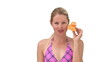 Blond woman in swimsuit playing with a plastic duck