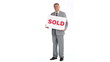 Real estate agent holding sold sign