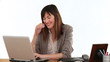 Businesswoman laughing in front of her laptop