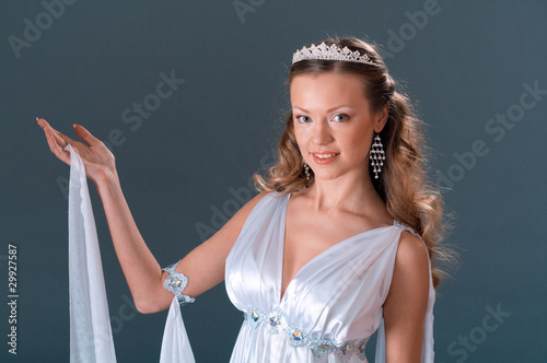 Photo: female wearing white dress in antique style . female wearing white dress in antique style .