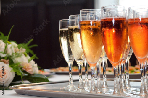 Photo: glasses of champaign on the tray with a bouquet glasses of champaign on the tray with a bouquet