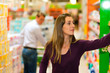Man and woman in supermarket with shopping cart