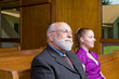 Senior Caucasian Man and Young Woman Sitting in Church Pew