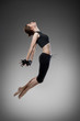 jumping young dancer on black