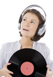 happy brunette in headphones with vinyl record over white