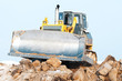 bulldozer loader at winter frozen soil excavation works