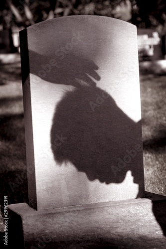 Photo: Shadow Of Hand Over Head Of Grieving Man At Grave Site Shadow Of Hand Over Head Of Grieving Man At Grave Site
