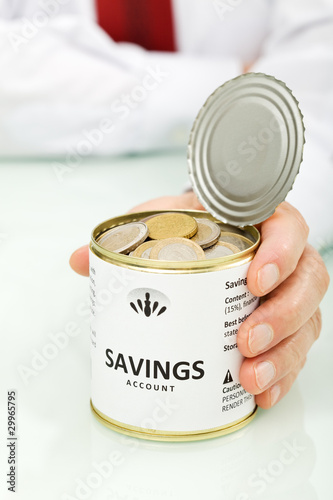 Photo: Senior businessman hands holding can with coins Senior businessman hands holding can with coins
