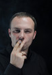 young man smokes a cigarette