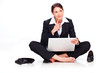 Young business woman sitting on the floor with laptop