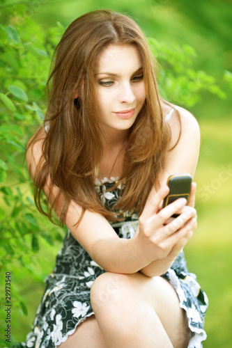 Photo: Beautiful young woman with mobile phone Beautiful young woman with mobile phone