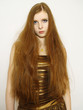 Foto: young woman with long red hair in dress young woman with long red hair in dress