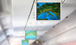 Lcd monitor showing a map of Europe inside salon of aircraft