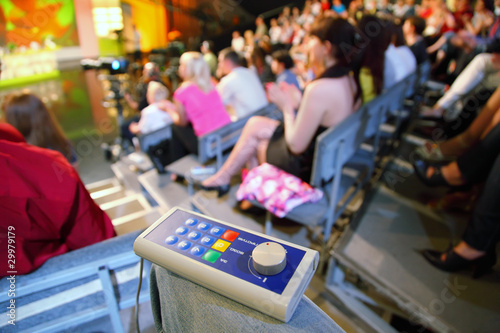 Photo: Voting device lies on knee in auditorium on television broadcast Voting device lies on knee in auditorium on television broadcast