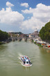 Boat on Tiber river, Sant' Angelo Bridge and Basilica