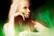 Luxury blond woman model with big ring in magic green mist