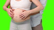 Man stroking the round belly of his pregnant wife