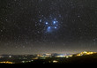 The Universe above city lights. The Pleiades star cluster.