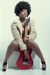 Young beautiful guitar player, studio portrait