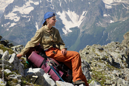 Photo: Girl sitting on the backpack Girl sitting on the backpack