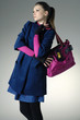 Fashion girl with handbag posing in light background Fashion girl with handbag posing in light background