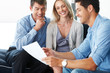 Consultant discussing investment plan with young couple