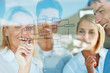 Businesswoman with colleagues drawing an organization chart on a