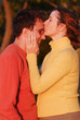 Young woman kisses her boyfriend's with tenderness
