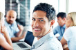 Successful businessman in meeting with colleagues at back