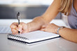 Photo: Woman's hand with pen writing down notes Woman's hand with pen writing down notes