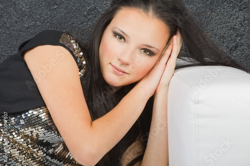 Photo: young woman lying on a sofa young woman lying on a sofa