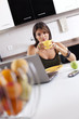 Modern woman reading e-mails at her breakfast