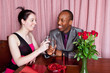 Mixed race couple toasting each other