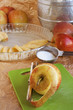 Peeled apple with pie ingredients in the background