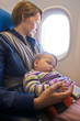Photo: Mother and baby on aeroplane Mother and baby on aeroplane