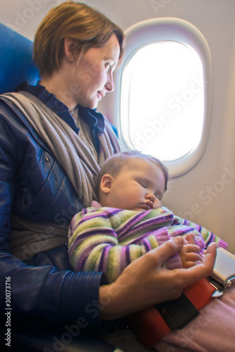 Photo: Mother and baby on aeroplane Mother and baby on aeroplane
