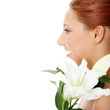 Portrait of the attractive girl with lily flower in hand