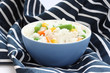 Blue bowl with cooked rice with mixed vegetable