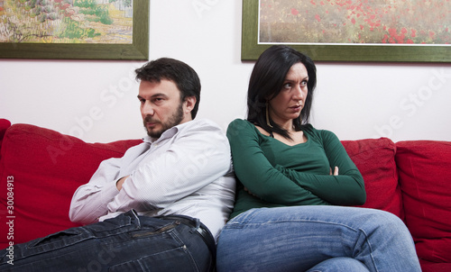 Photo: Angry Adult Couple Sitting on Sofa Angry Adult Couple Sitting on Sofa