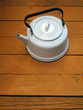 Old kettle on the wooden floor Old kettle on the wooden floor